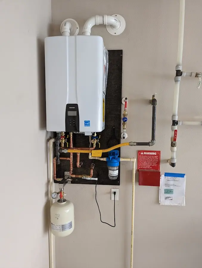 Professional plumber installing copper piping in a Elkhorn home